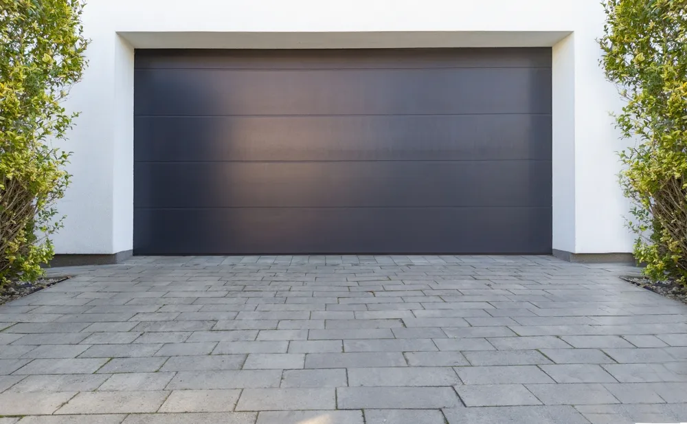 Sleek black modern garage door on contemporary home