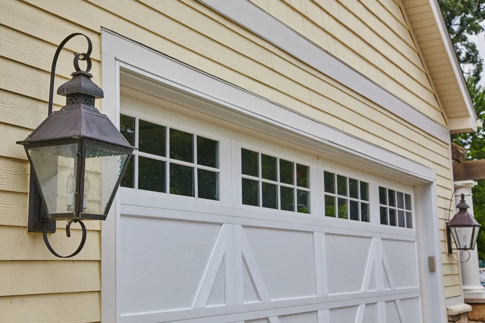 White carriage garage door with decorative lanterns
