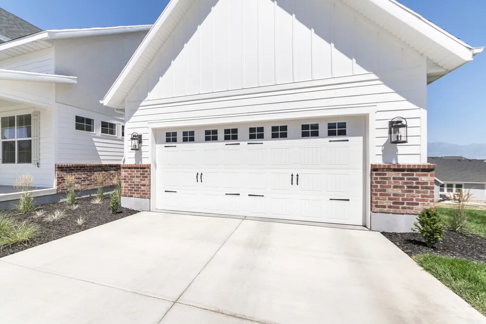 White traditional garage door on brick home