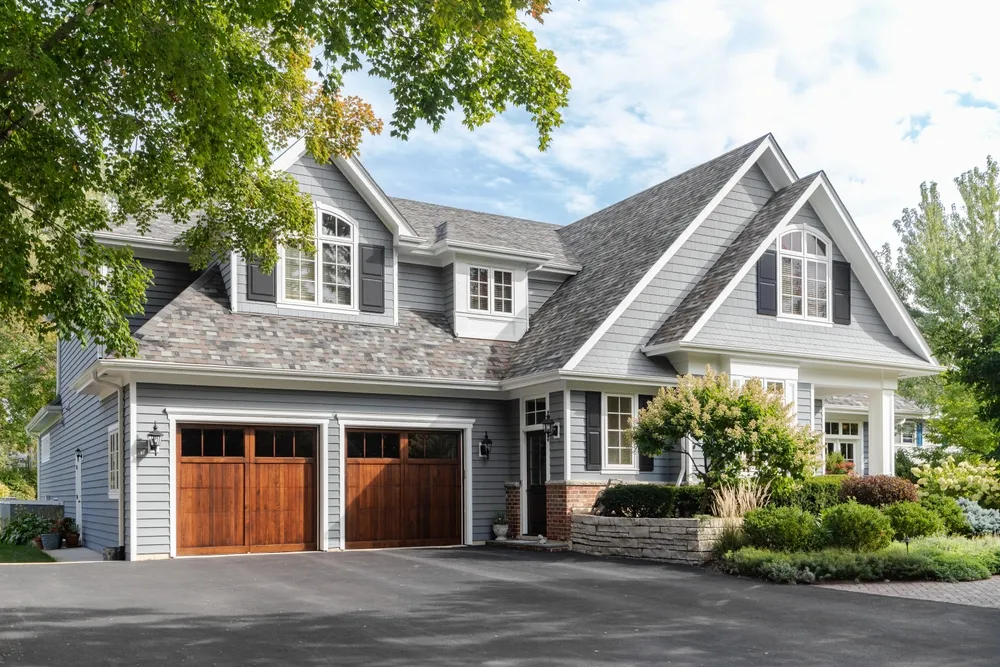 Wood garage doors on gray home exterior